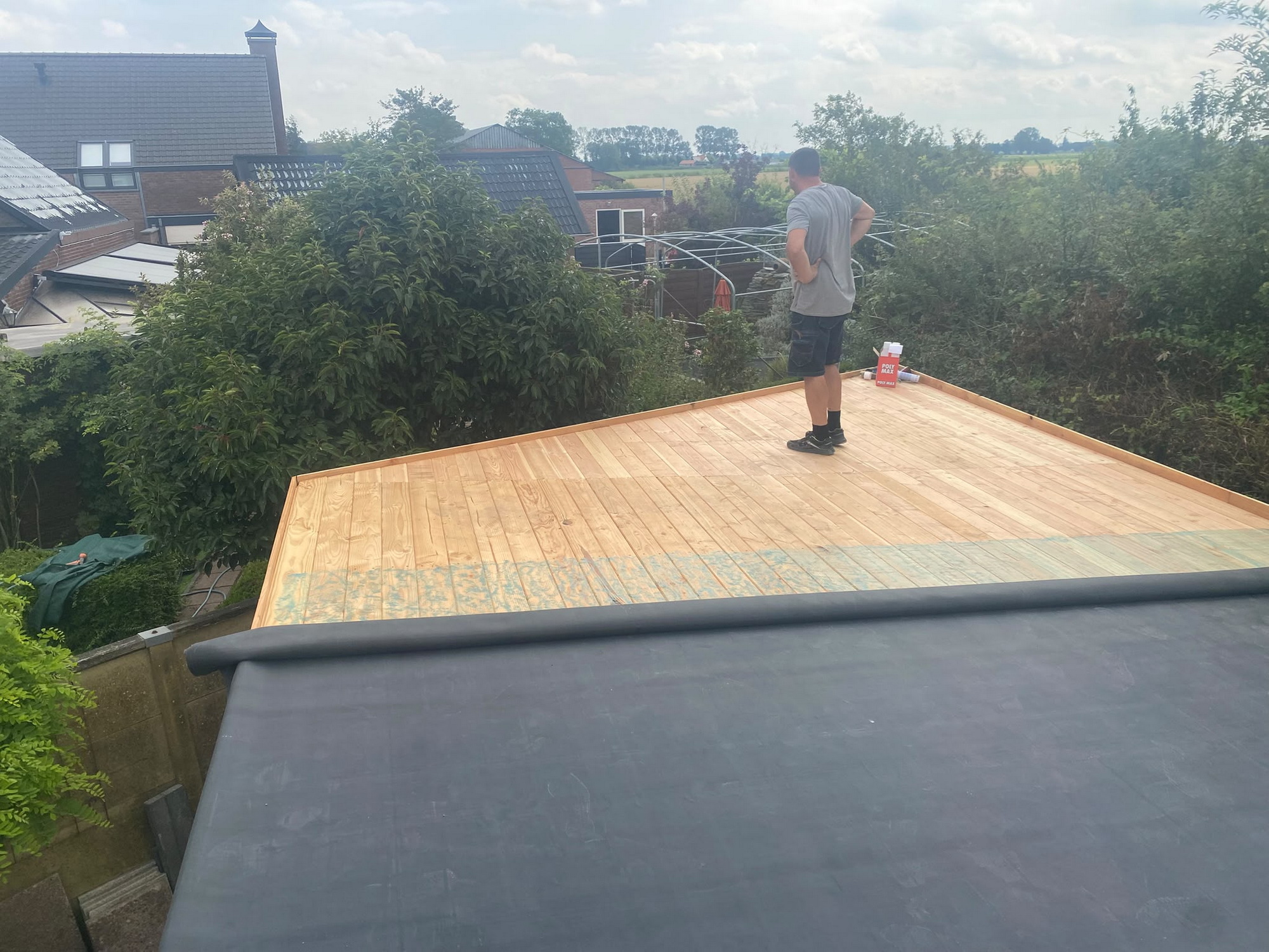 Worker completing the timber roof deck before the final membrane finish