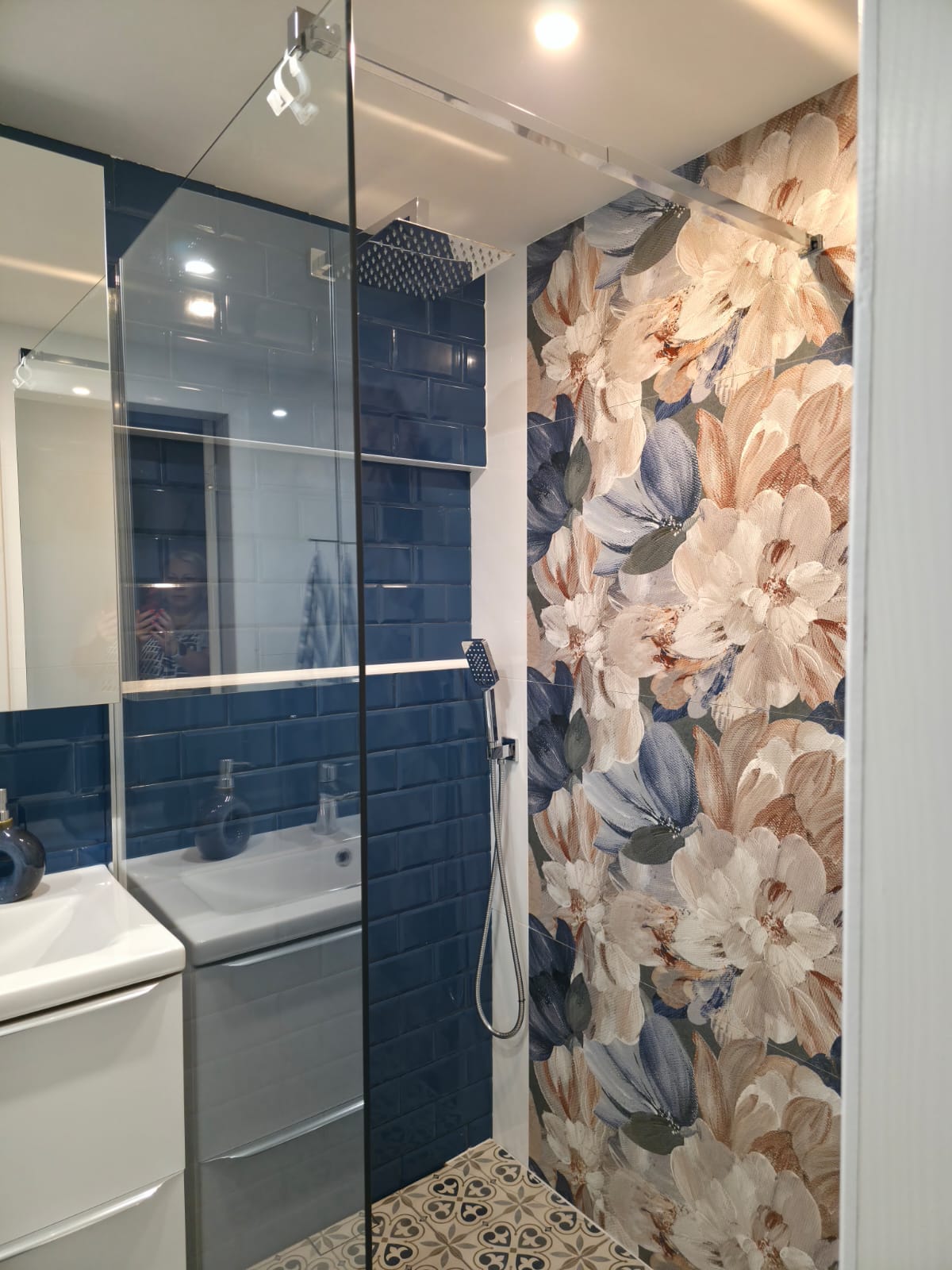 Bathroom with dark blue wall tiles and floral shower feature wall