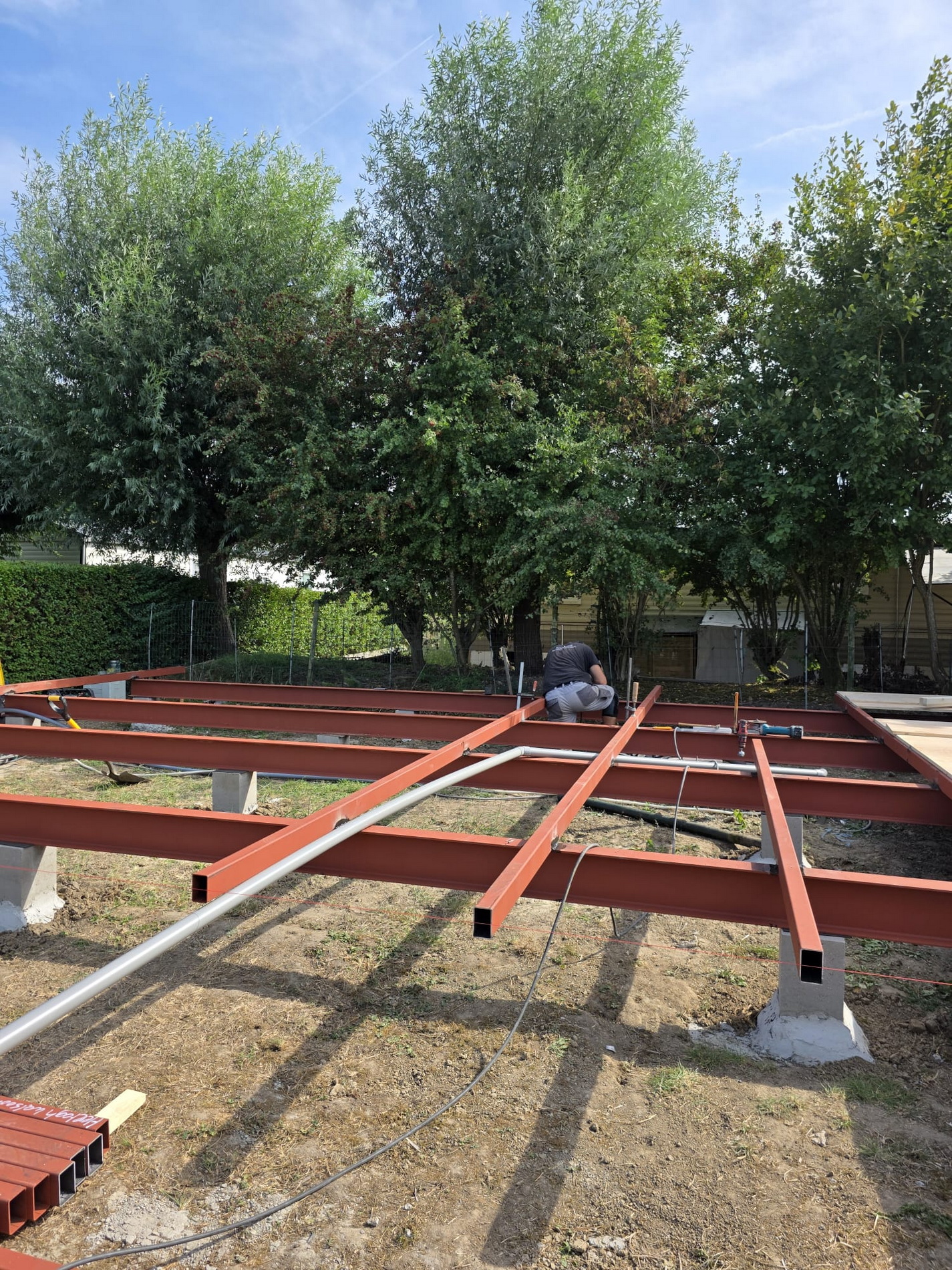 Steel frame grid assembled on concrete piers with drainage pipes underneath