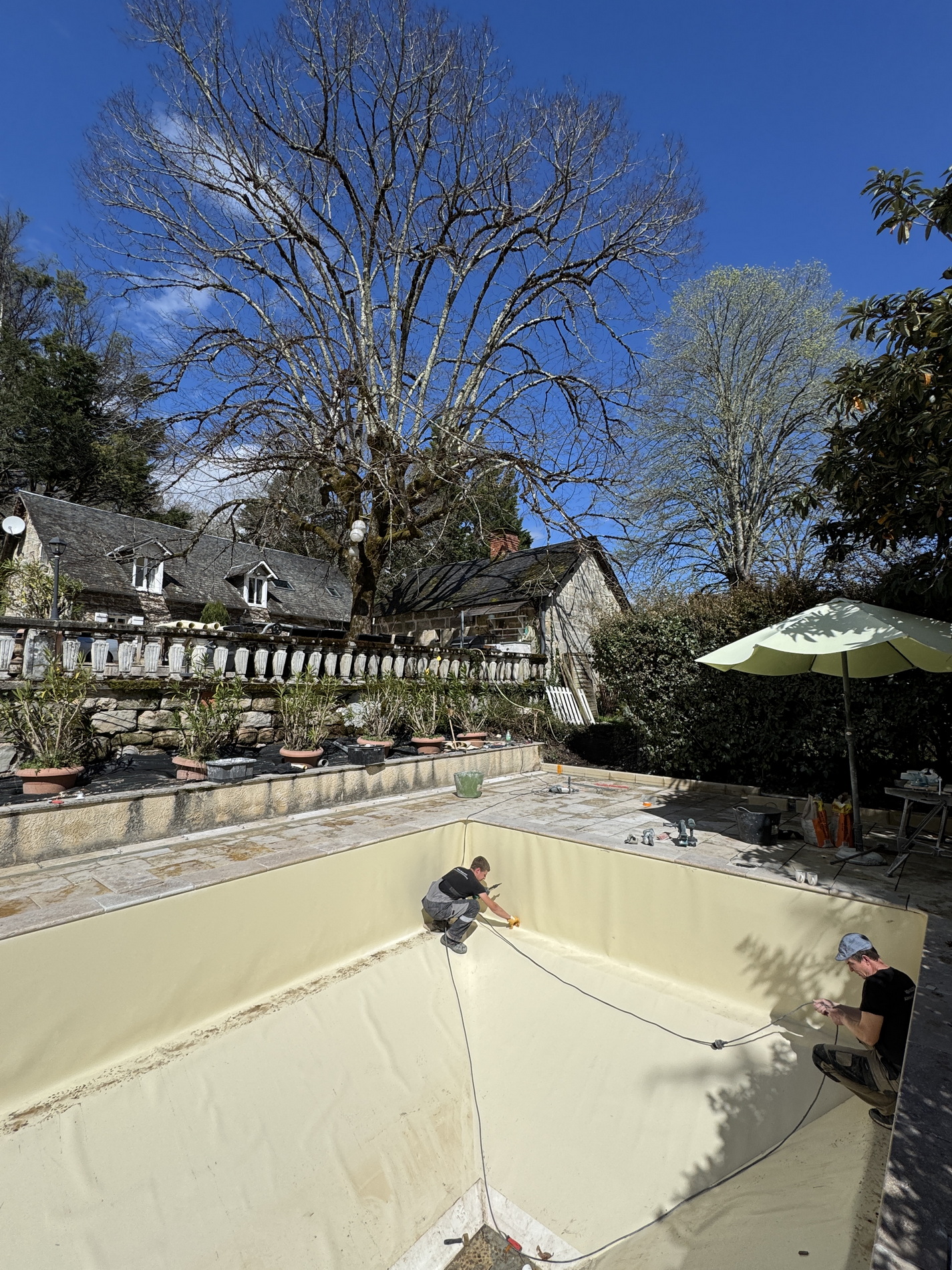 Pool terrace under renovation with new stone paving and construction tools