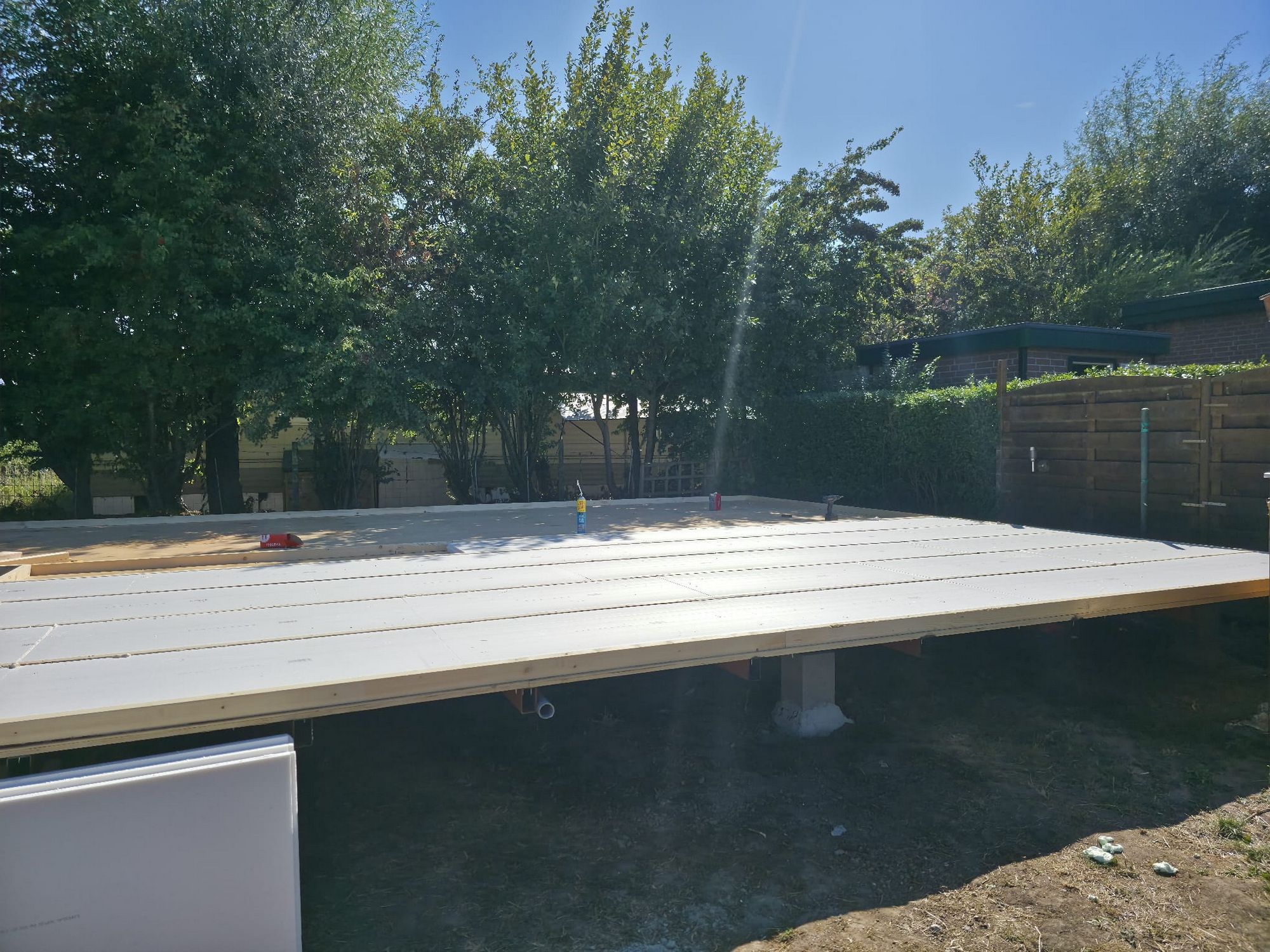 Insulated floor platform nearing completion on the raised steel frame