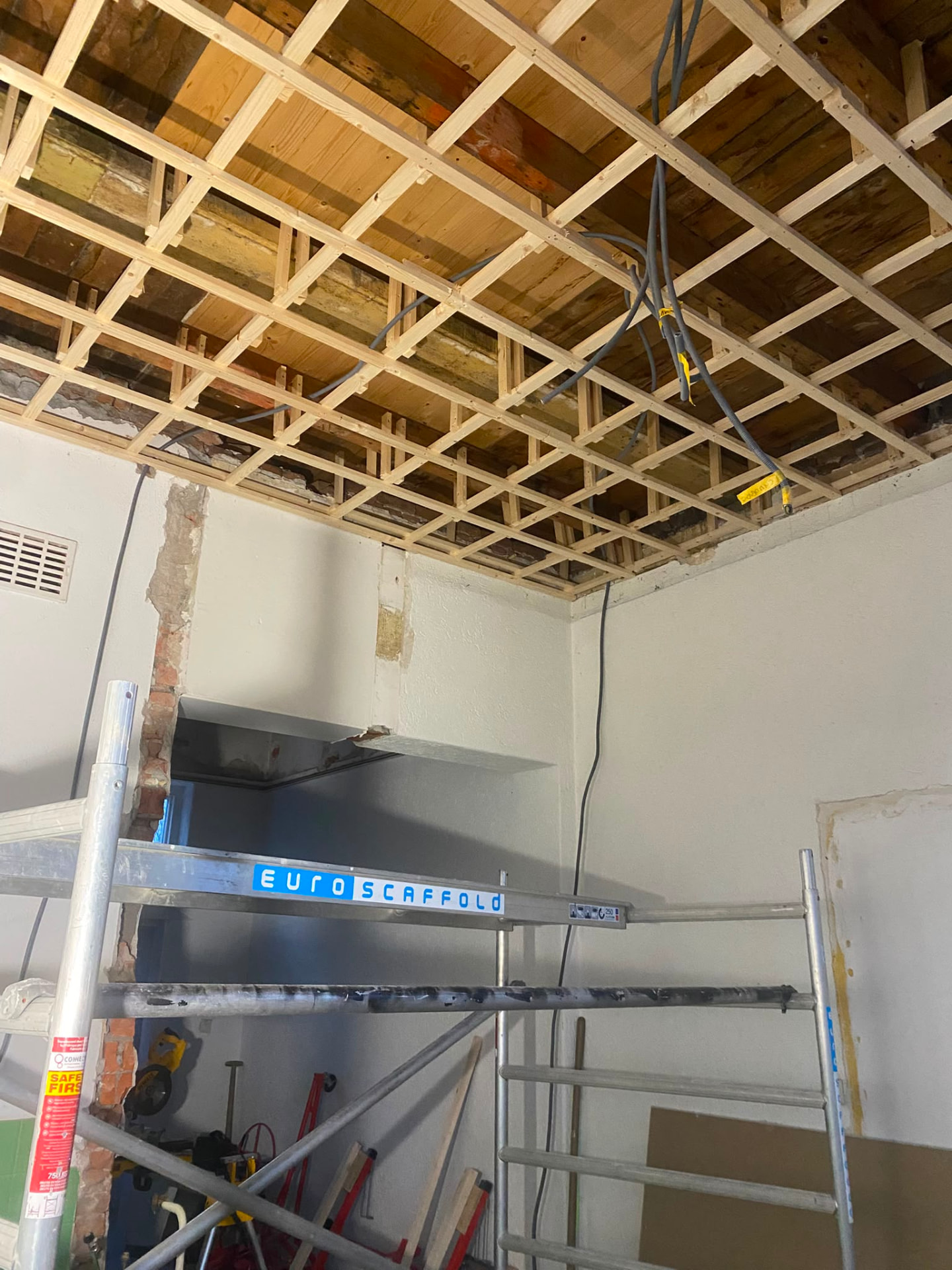 New timber ceiling structure with cabling installed during a renovation
