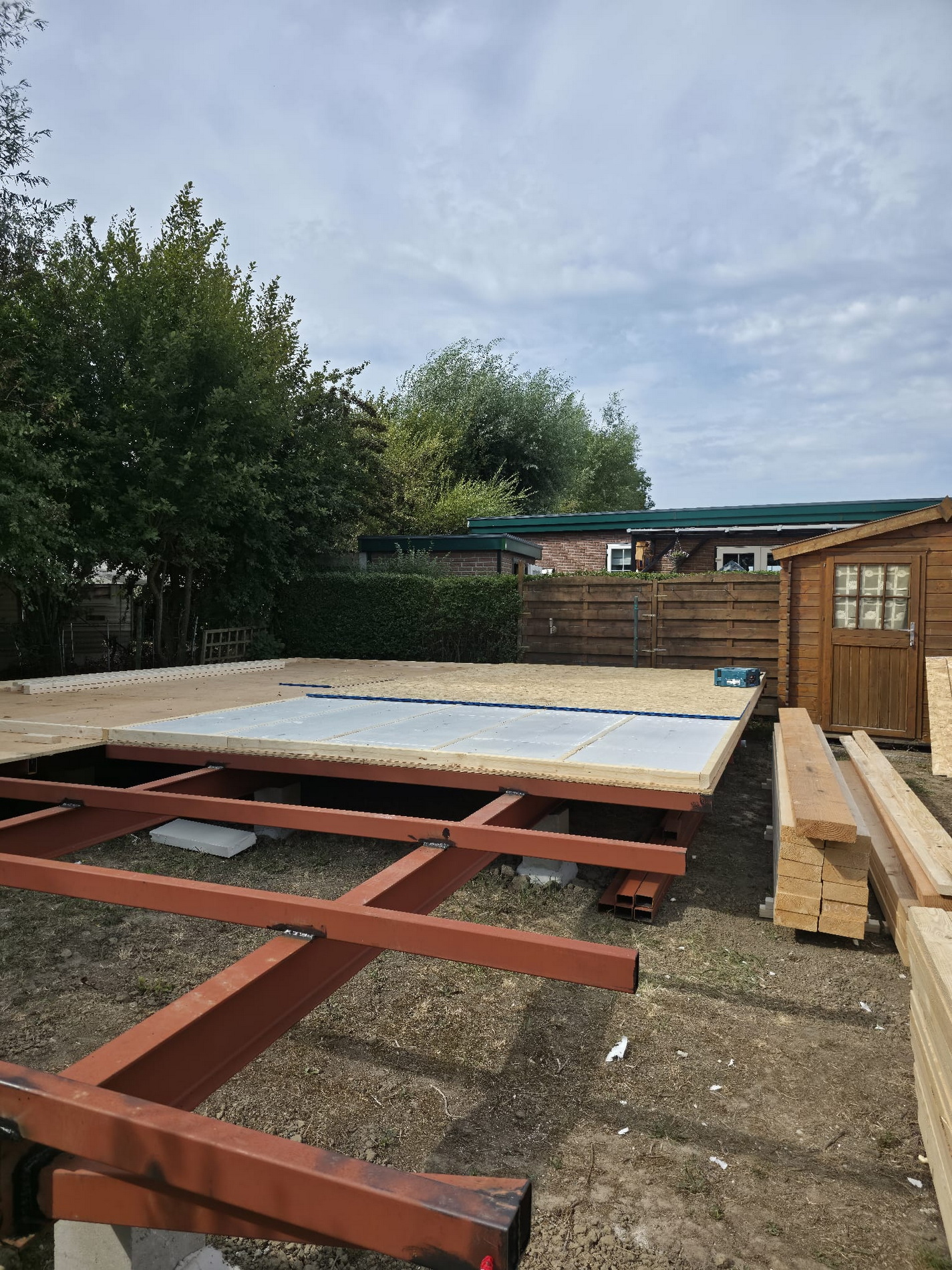 Steel frame partly covered with boards and insulation panels for the floor