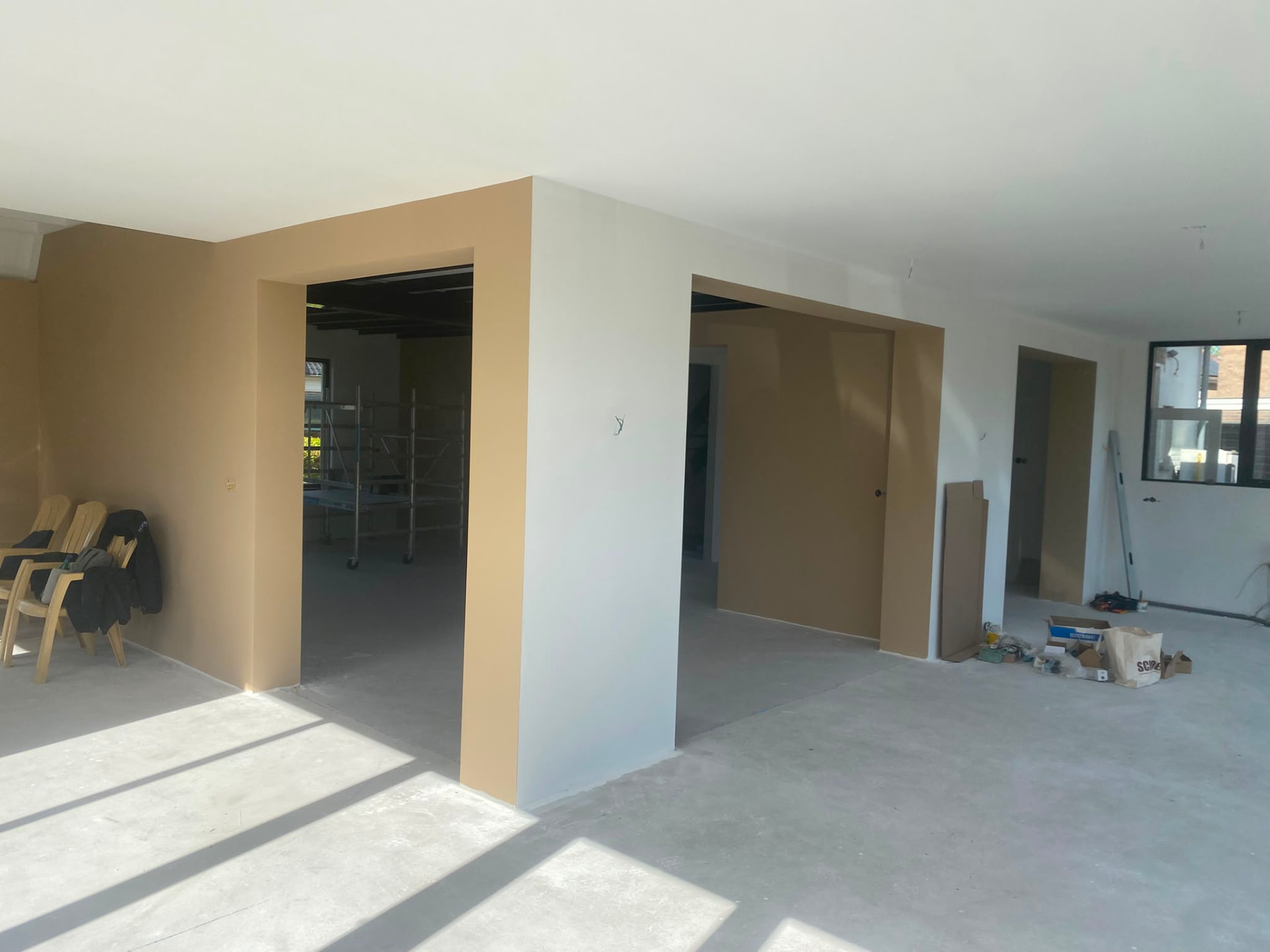 Interior with painted partition walls, doorways and scaffolding during finishing