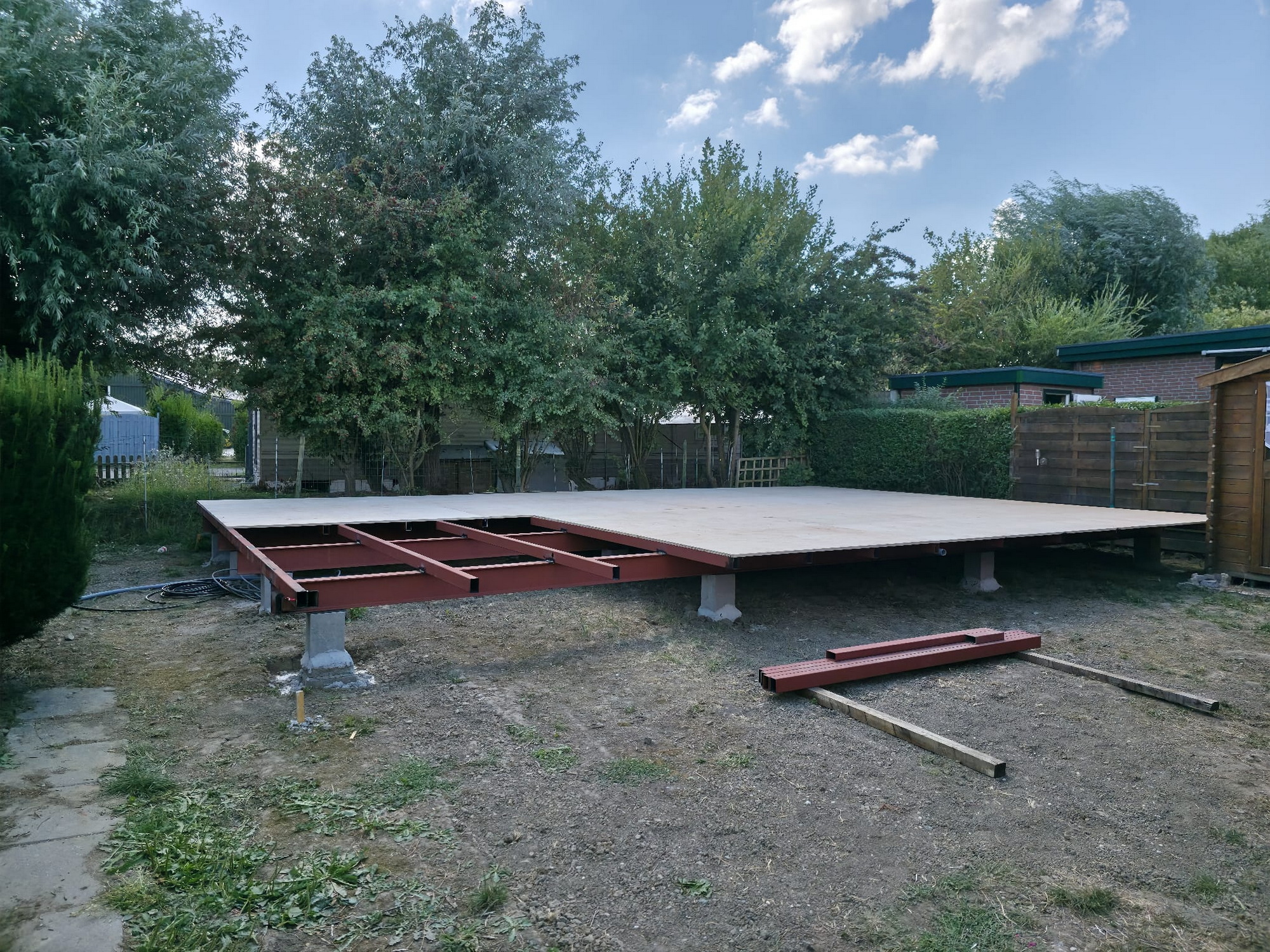 Wide view of the partly completed floor deck on its steel foundation