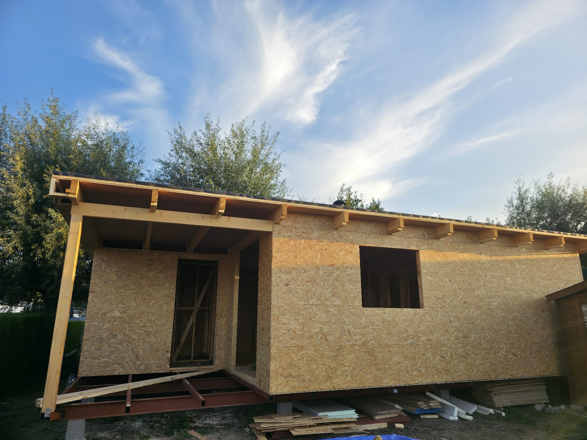 Timber structure enclosed with OSB wall panels and roof overhang