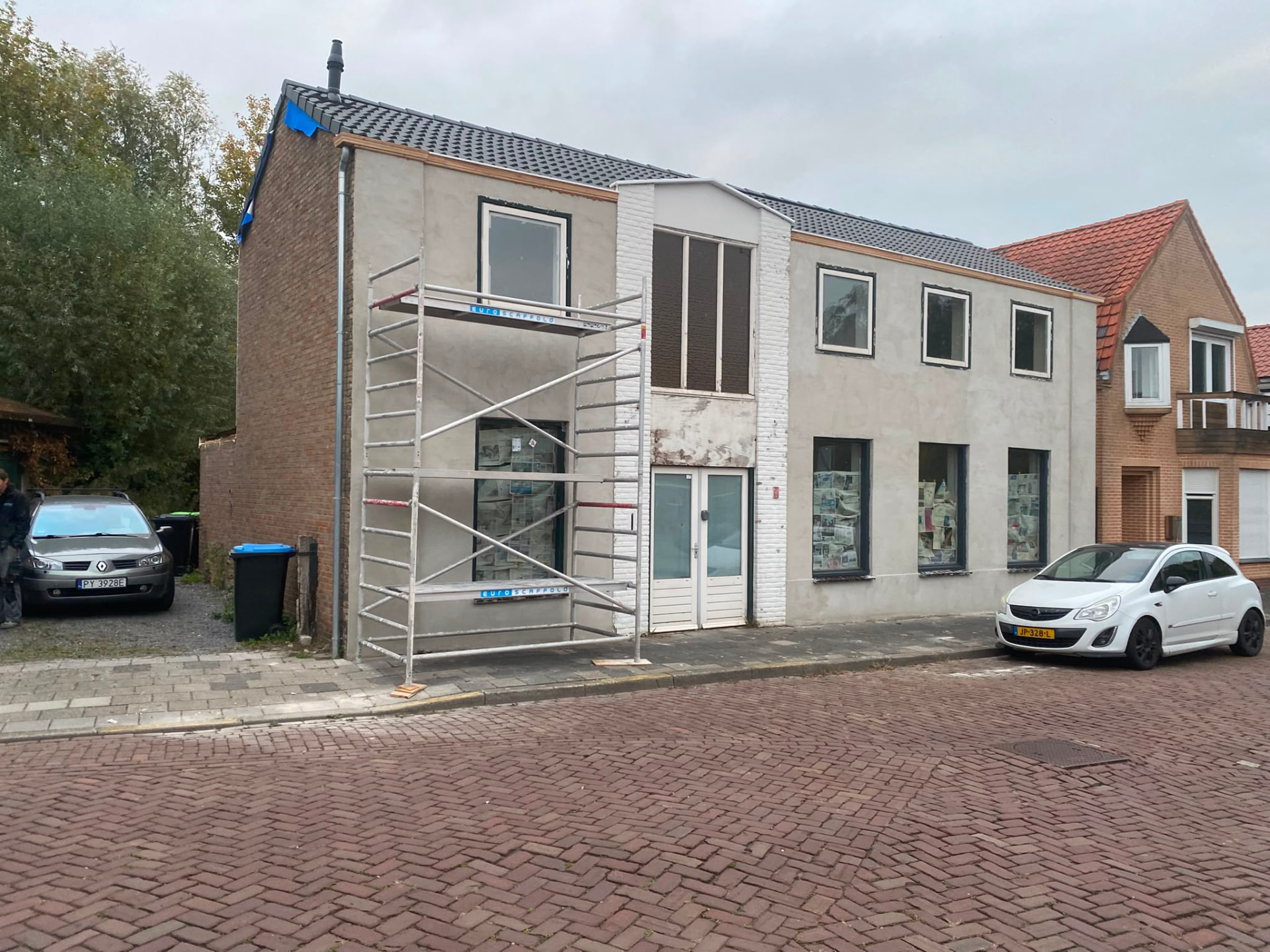 House facade renovation with new render, brick detailing and window frames