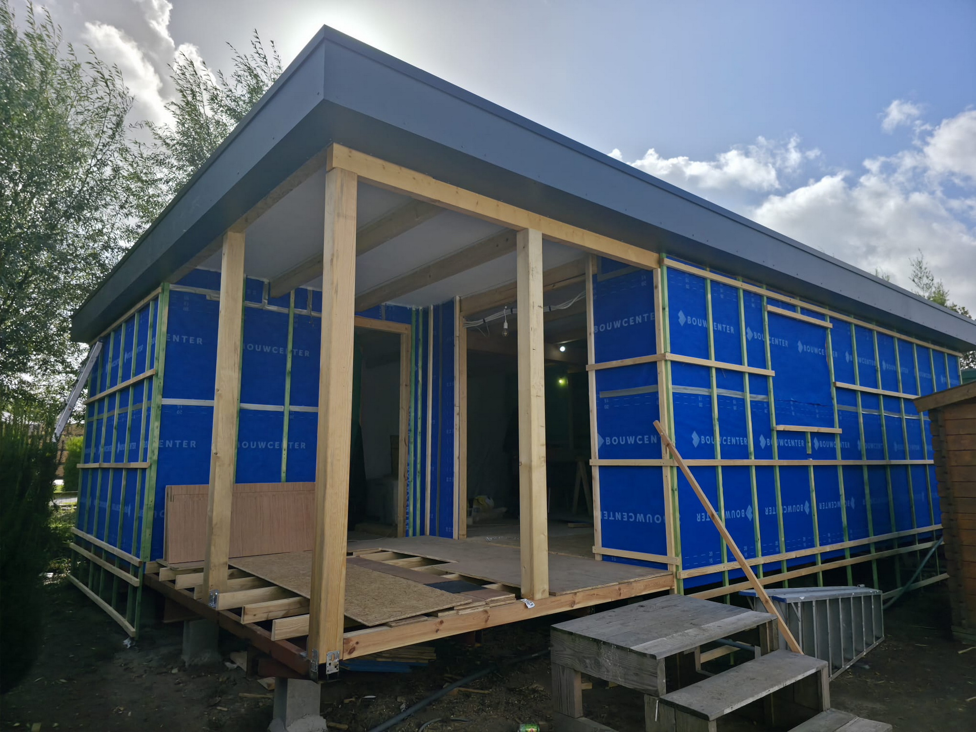Weatherproof exterior wrap, timber battens and covered entrance canopy