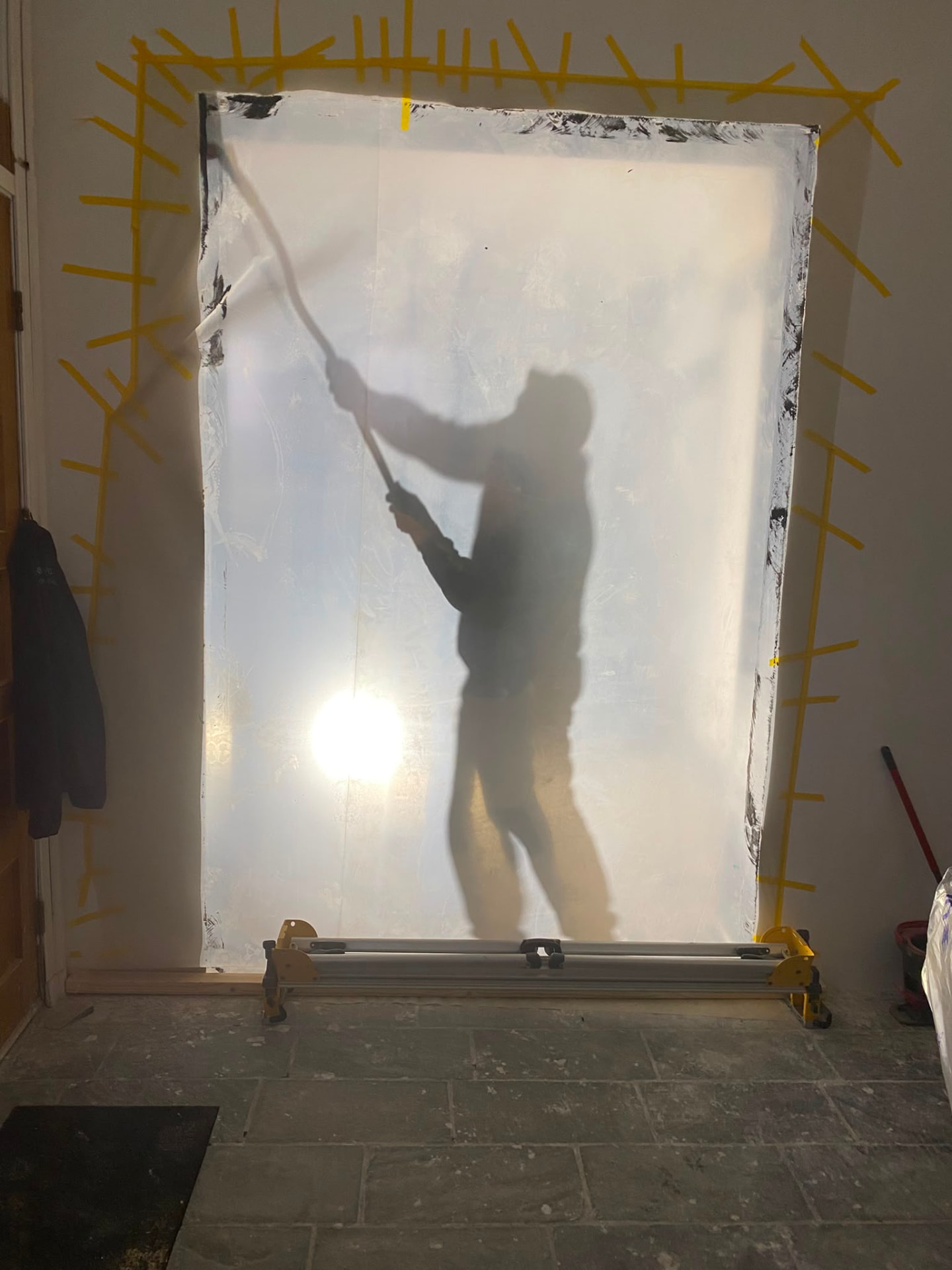 Interior room prepared for painting with dust sheets and masked edges