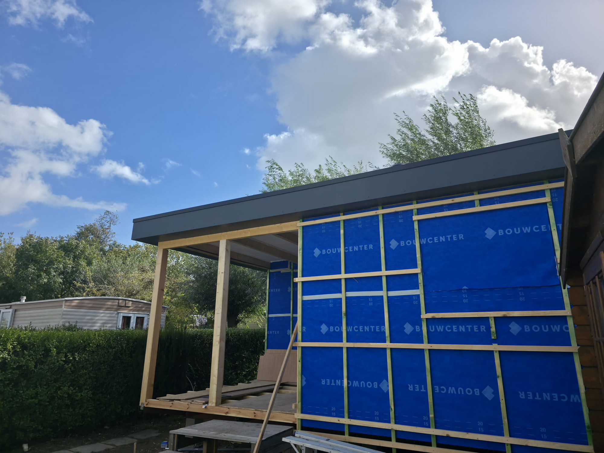 Exterior walls wrapped with blue weatherproof membrane and timber battens