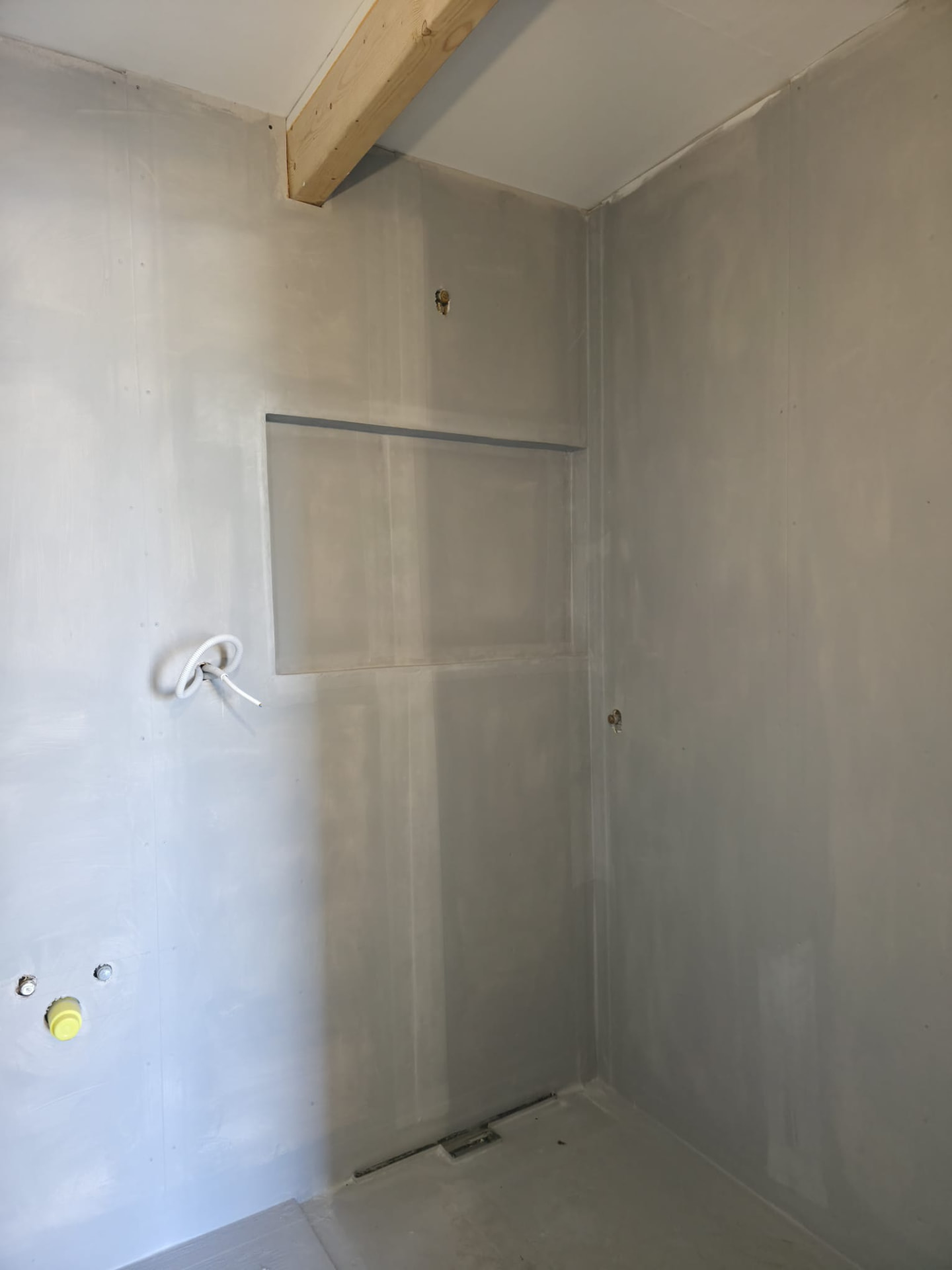 Bathroom drywall installation with built-in niche and plumbing rough-ins