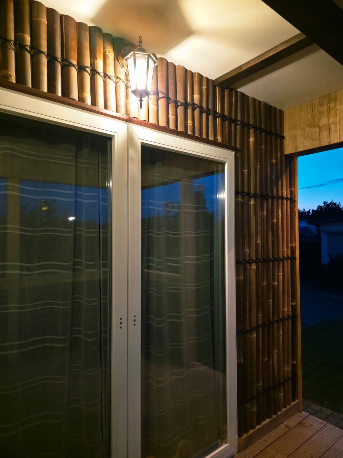 Bamboo wall finish and exterior lantern beside the terrace doors