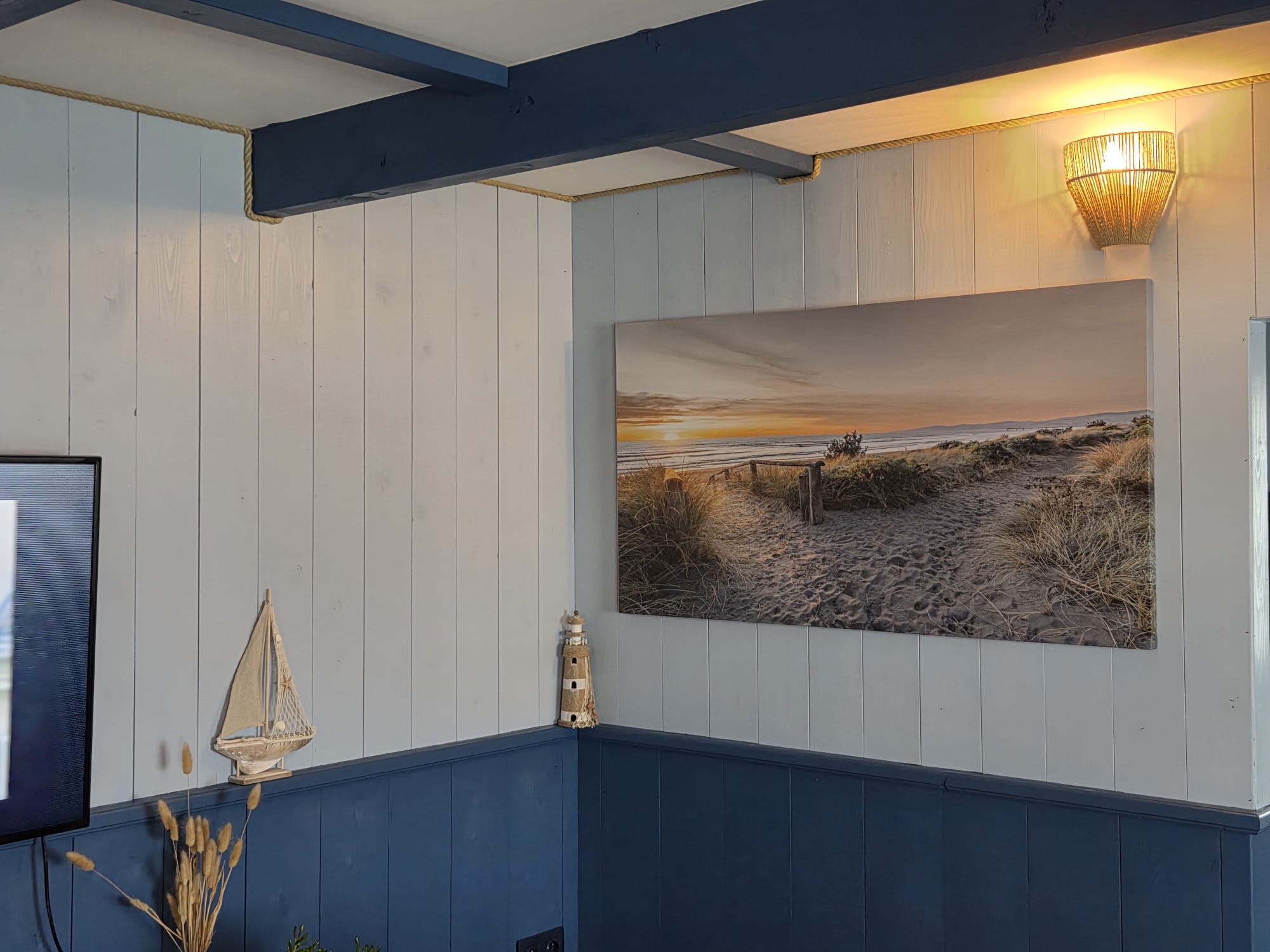 Freshly painted coastal-style panelled room in soft blue and white
