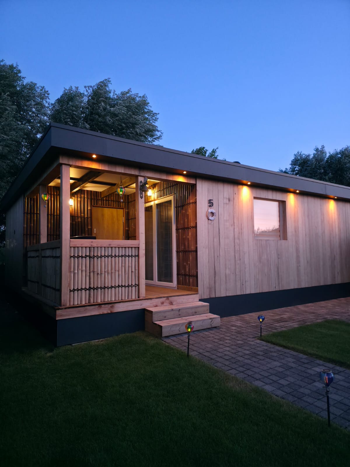 Completed timber building with illuminated covered terrace