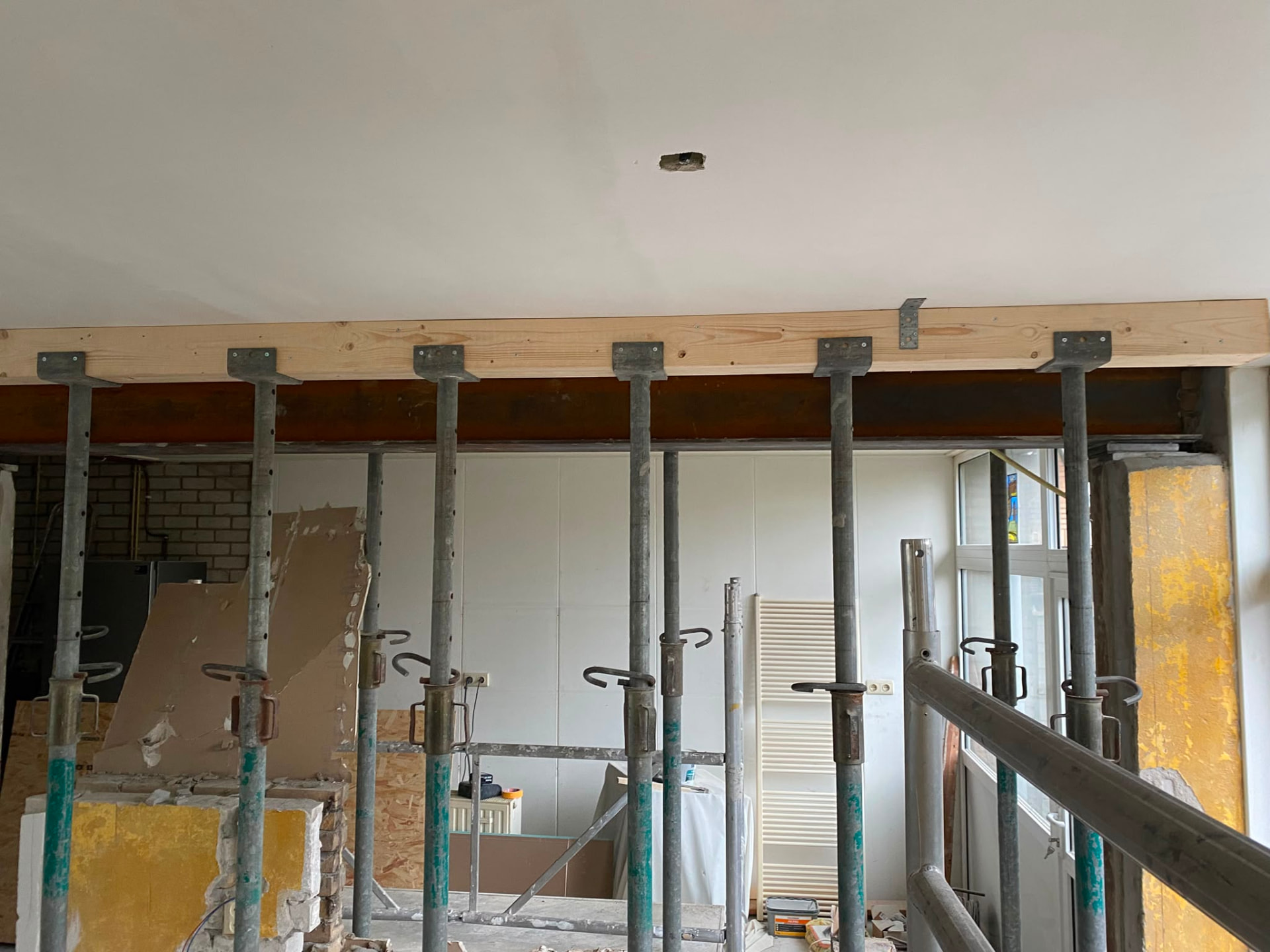 Structural renovation with support props and new timber beam during wall removal