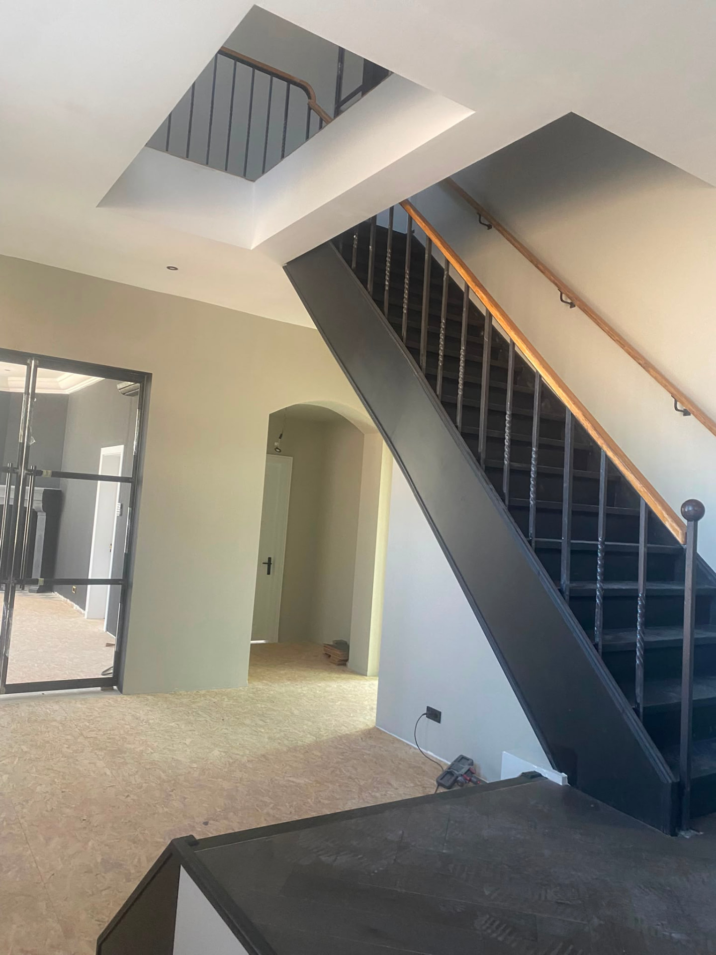 Renovated hallway with restored staircase and freshly finished walls